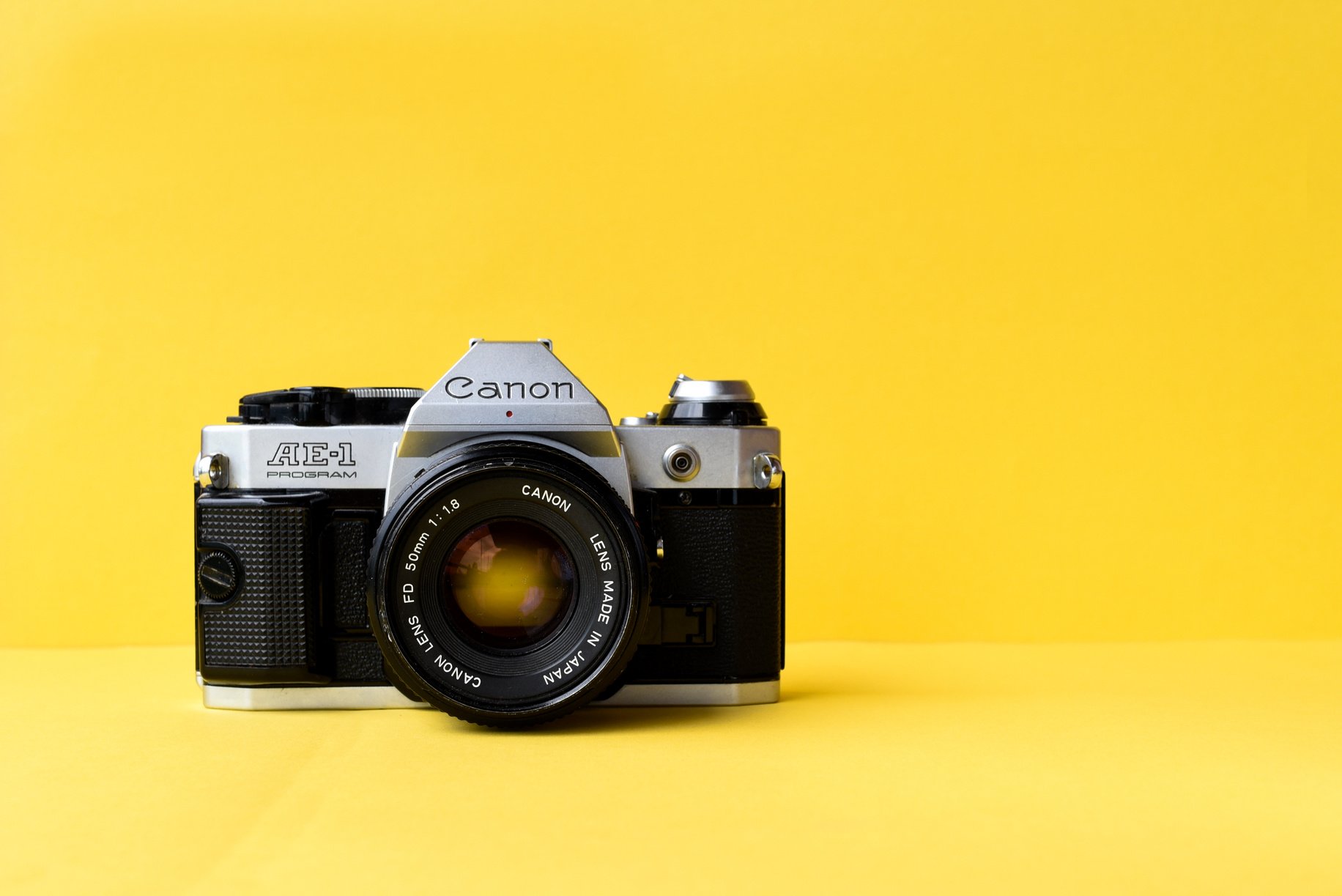 Film Camera on Yellow Background